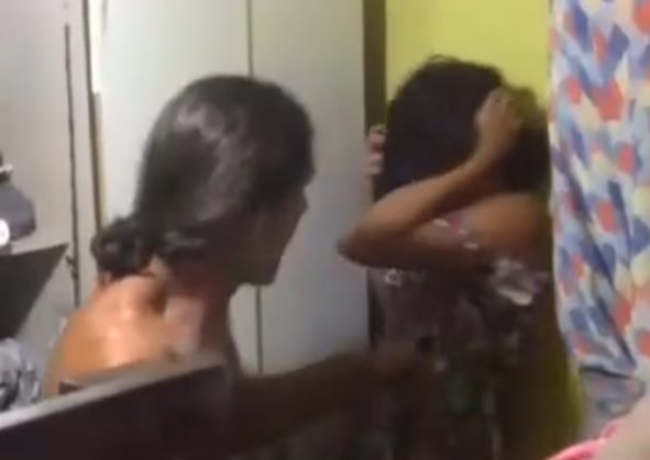 Husband beating wife for cell phone in Brazil.