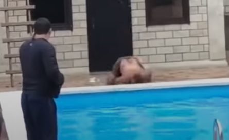 Man on the roof jumps into the pool but hits the floor.