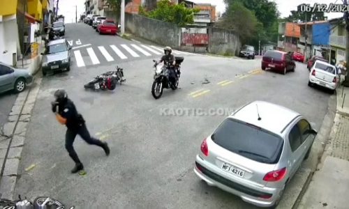 The policeman falls off his motorcycle, but the chase continues.