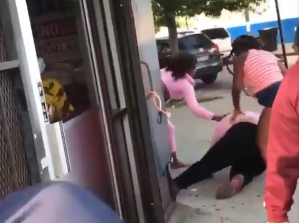Woman being physically assaulted by two women in an unfair fight.