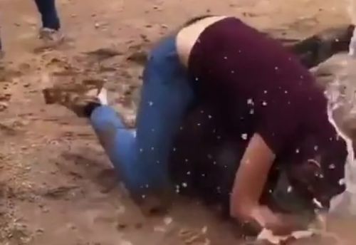 Girls fighting in the mud puddle for no apparent reason.