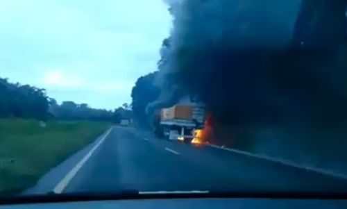 Terrible traffic accident involving trucks. Father tries to save son from the flames.