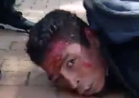 Alleged thief being beaten up by people furious with his criminal acts.