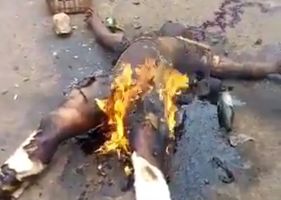 Child molester being killed and burned by the population.