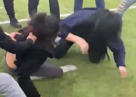 Girls fighting in the middle of the field instead of playing.