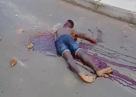 Man brutally murdered and left on the asphalt with a pool of blood.