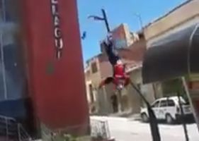 Man throws himself into suicide from above a building and dies miserably.