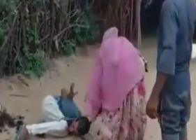 Woman beating husband with ax for treason in India.