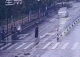 Woman is run over by car in China and flies through the air because of the impact.