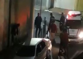 Brazilian policemen fighting with several scoundrels in the middle of the street in a generalized brawl.