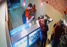 Client reacts to the robbery in the cafeteria and kills one of the robbers and a woman.