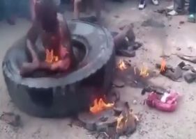 Man burning alive inside tire in Africa in public lynching.