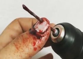 A drill drilling through finger in a self-mutilation session.