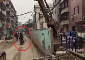 Biker is crushed by wall while passing by the construction site.