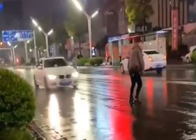 Supposedly drunk guy getting hit by car in the middle of the street.