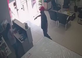 Thieves try to rob a woman alone in the store, but are shot by an armed employee in Brazil.