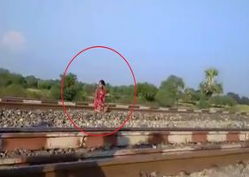Woman sits on train tracks and patiently waits for death in a terrible suicide.
