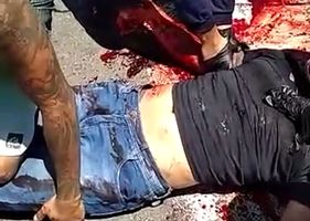Pedestrians try to rescue and help motorcyclist seriously injured in a traffic accident in Brazil.