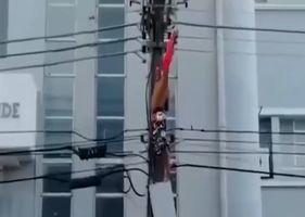 A man with psychological problems climbs a power pole and is electrocuted alive.
