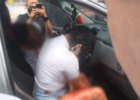 A man is shot dead inside a car with a woman in the passenger seat in Brazil.