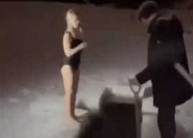 Woman disappears under ice after diving into icy hole and drowning in front of children during epiphany gain in Leningrad region, Russia.