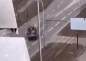 Russian army tank crushes civilian car in Ukraine during invasion for no apparent reason.