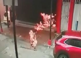 Woman sets fire to homeless man who was sleeping on the sidewalk.