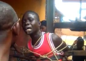Man being tortured eletrocuted in Africa.