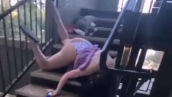 Apparently drunk woman tries to climb stairs but falls and ends up in an embarrassing position Photo 0001 Video Thumb
